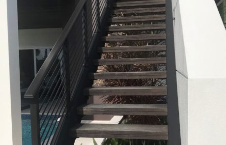An exterior metal stair railing.